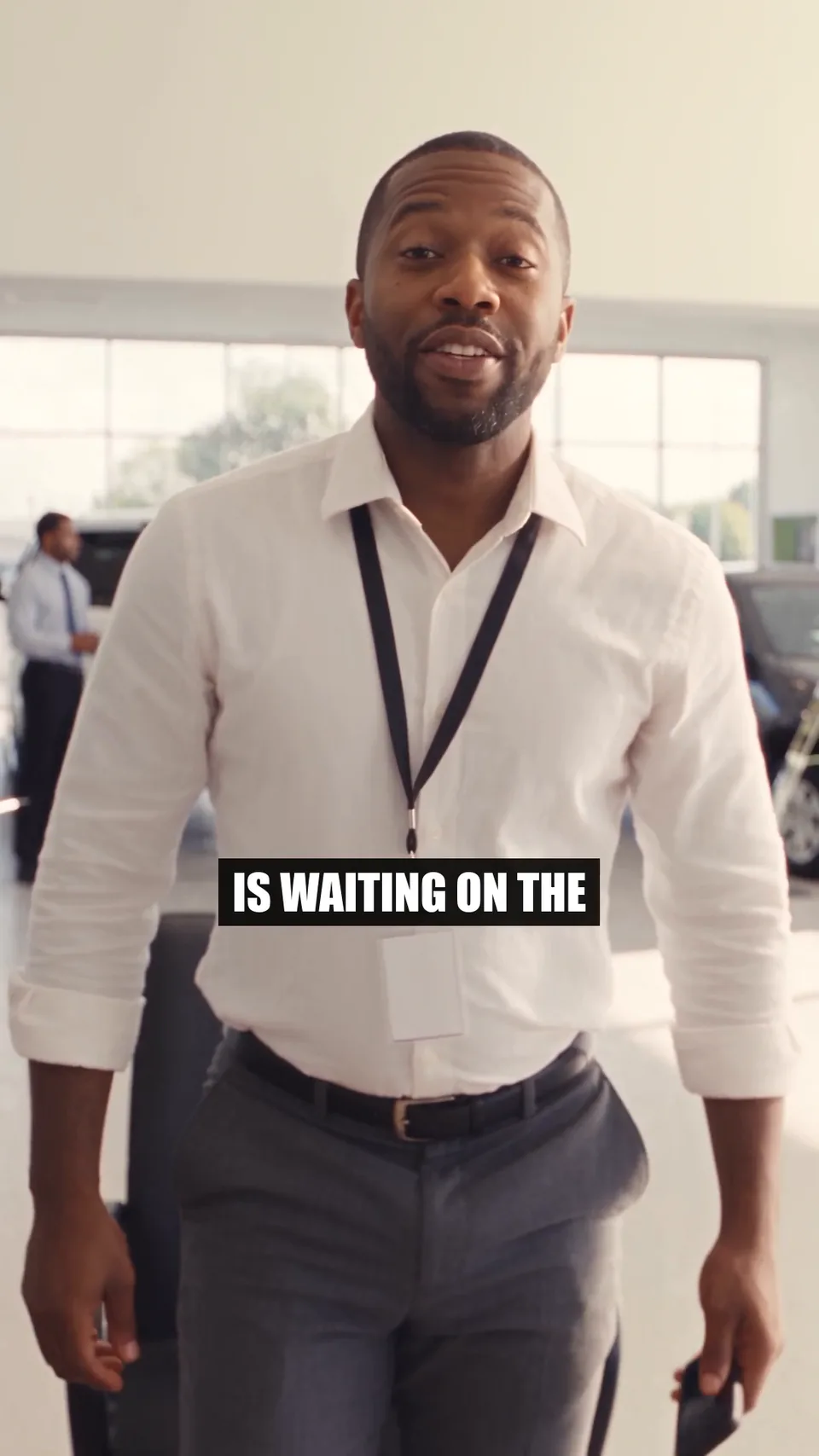 A frame of AutoLander’s Slow Day commercial: a salesperson in a showroom, captioned, as it runs on Facebook and Instagram Reels