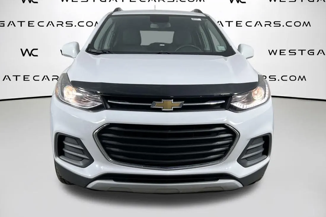 White Chevrolet Trax in a dealer studio photo covered by a website watermark, before AutoLander