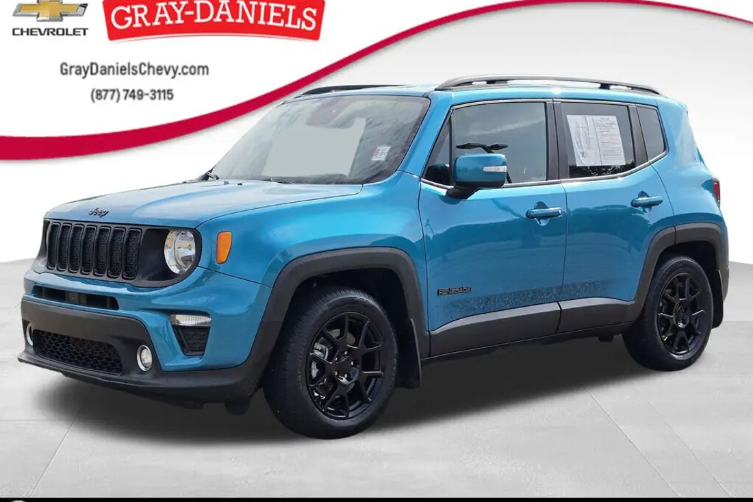 Jeep Renegade small SUV in a cluttered dealer lot photo, before AutoLander