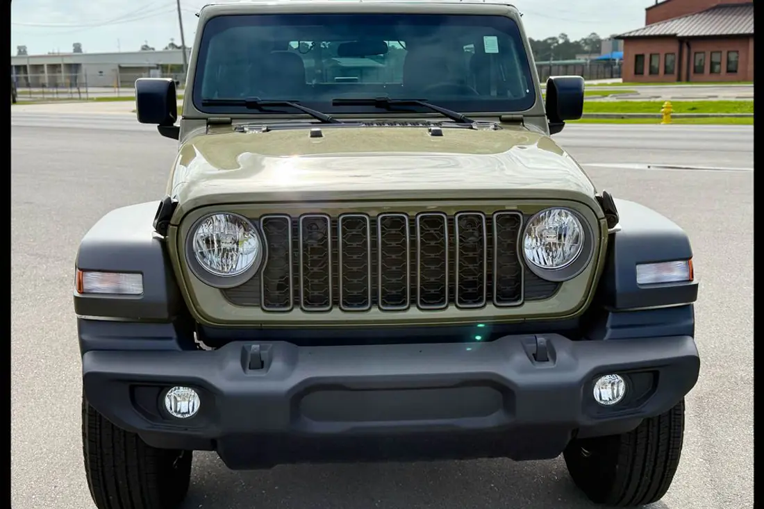 Raw dealership lot photo of a 2026 Jeep Wrangler before AutoLander