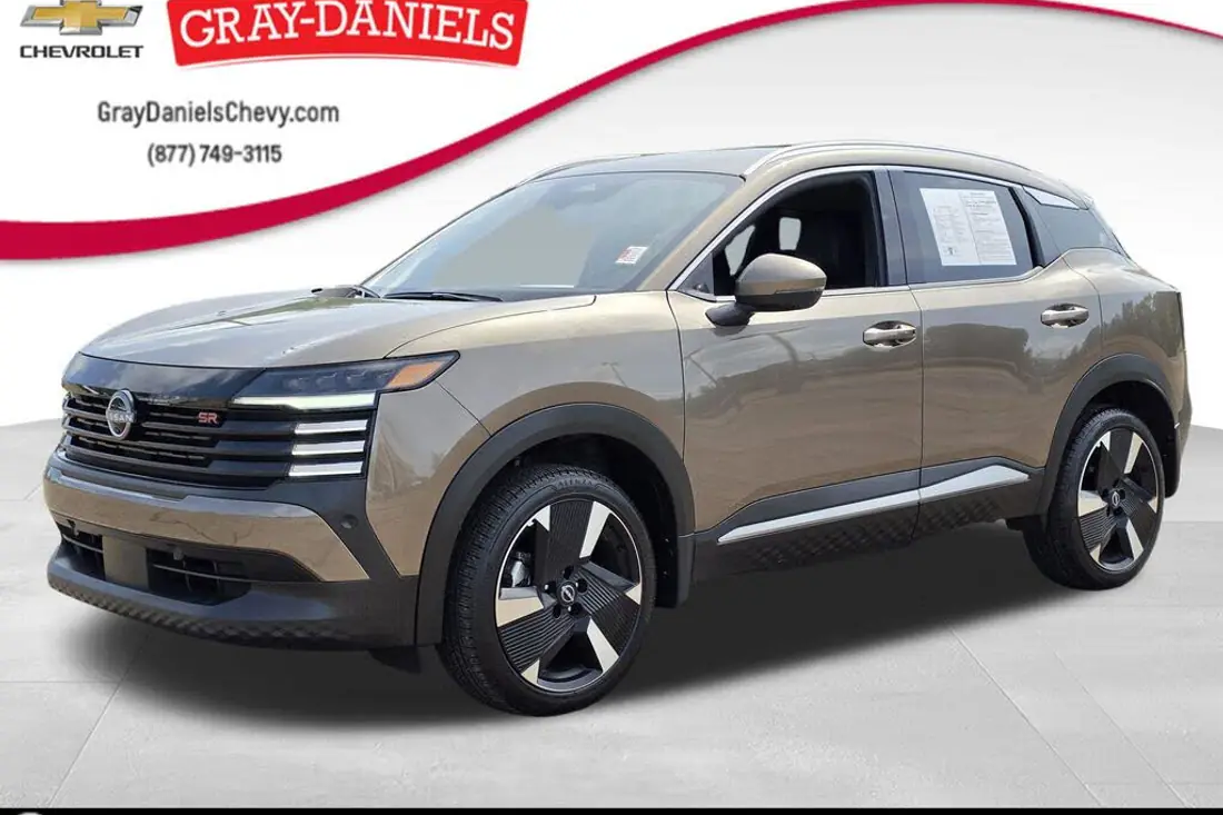 Raw dealership lot photo of a 2025 Nissan Kicks before AutoLander