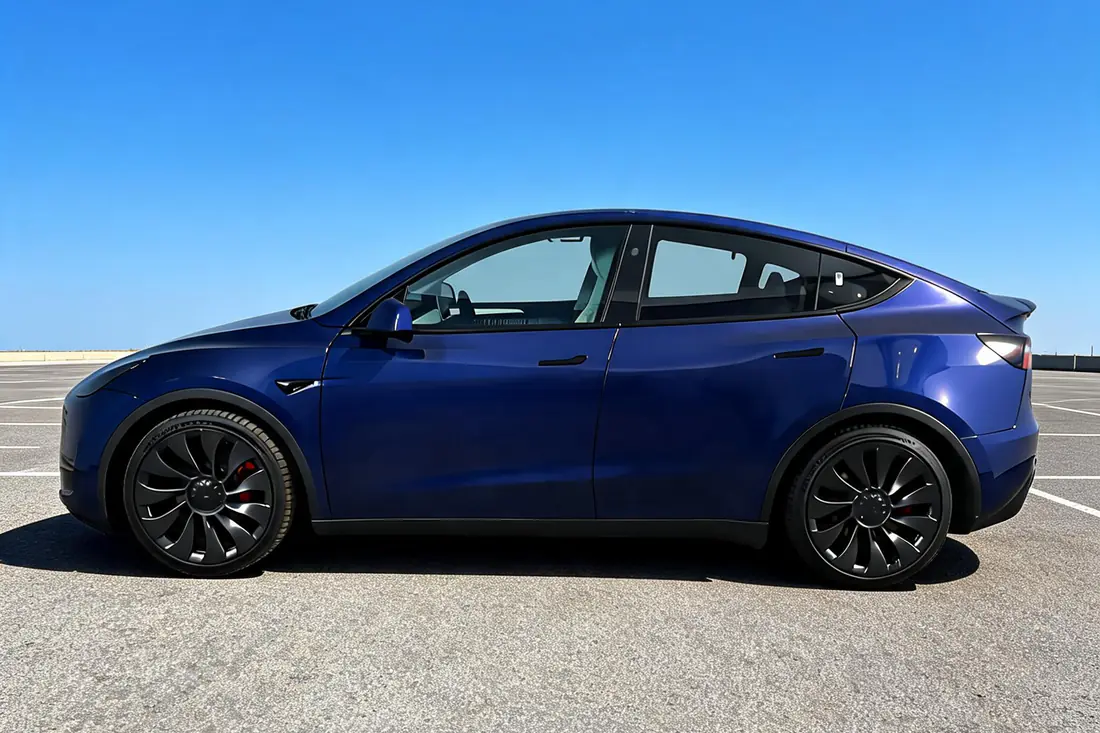 The same Tesla Model Y re-staged in a clean studio scene by AutoLander’s AI Photo Studio